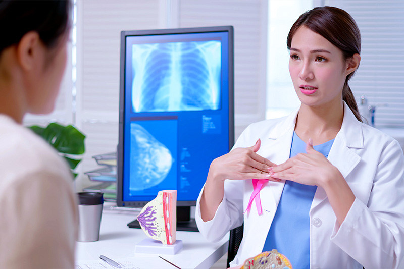 Breast surgeon talking to a patient about mammography services at St. Mary's Healthcare System.